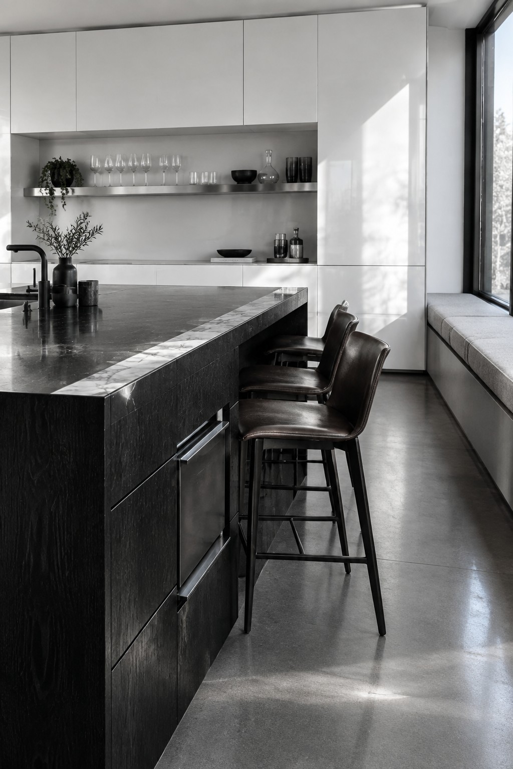 Modern kitchen with dark marble island, three leather barstools, and white cabinetry.