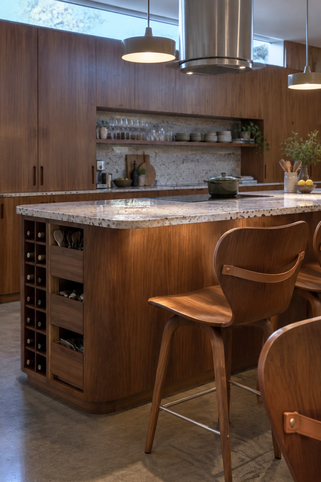Modern wooden kitchen island with bar stools, terrazzo countertop, and pendant lights