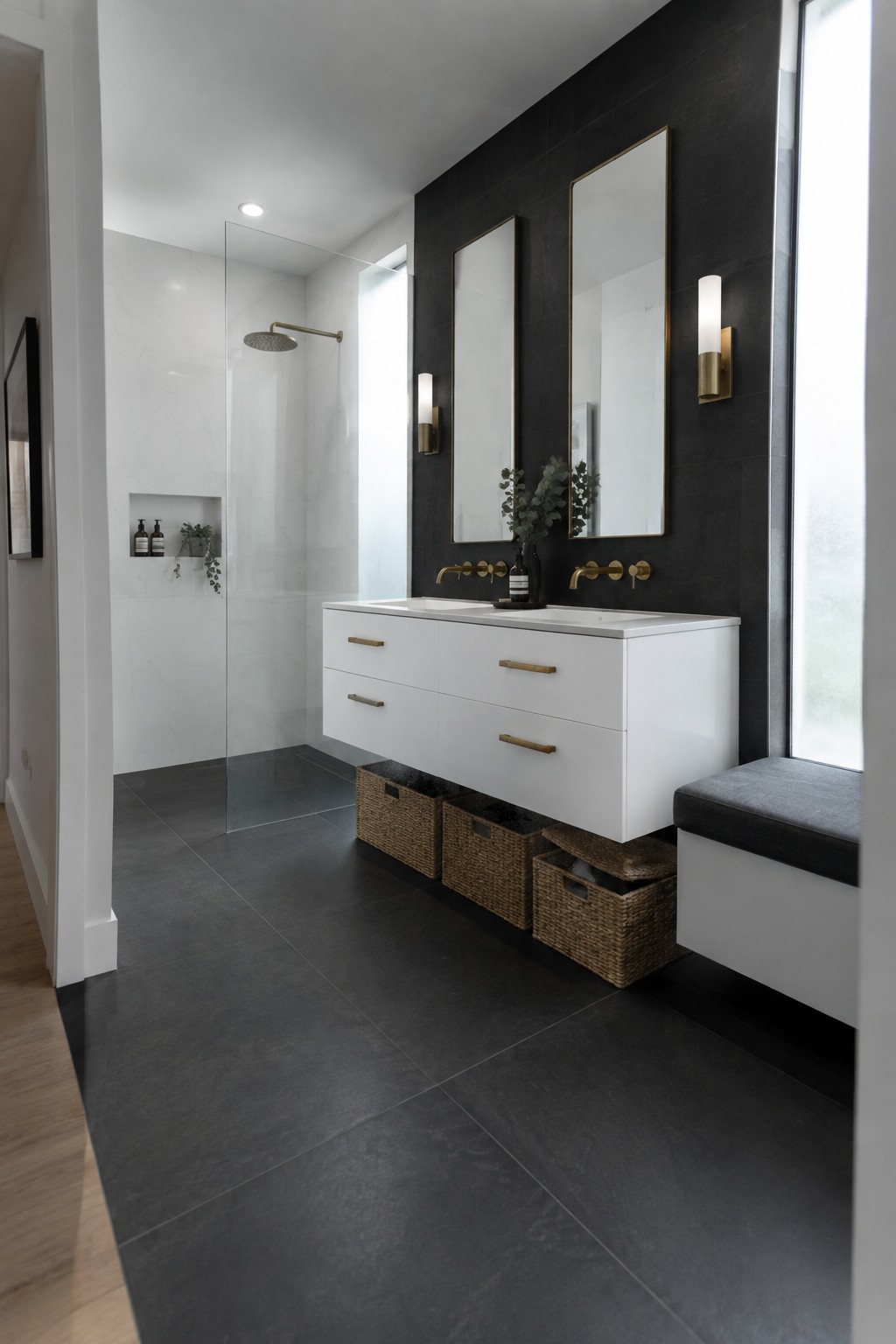 Modern bathroom with white floating vanity, black accent wall, and gold-framed mirrors.