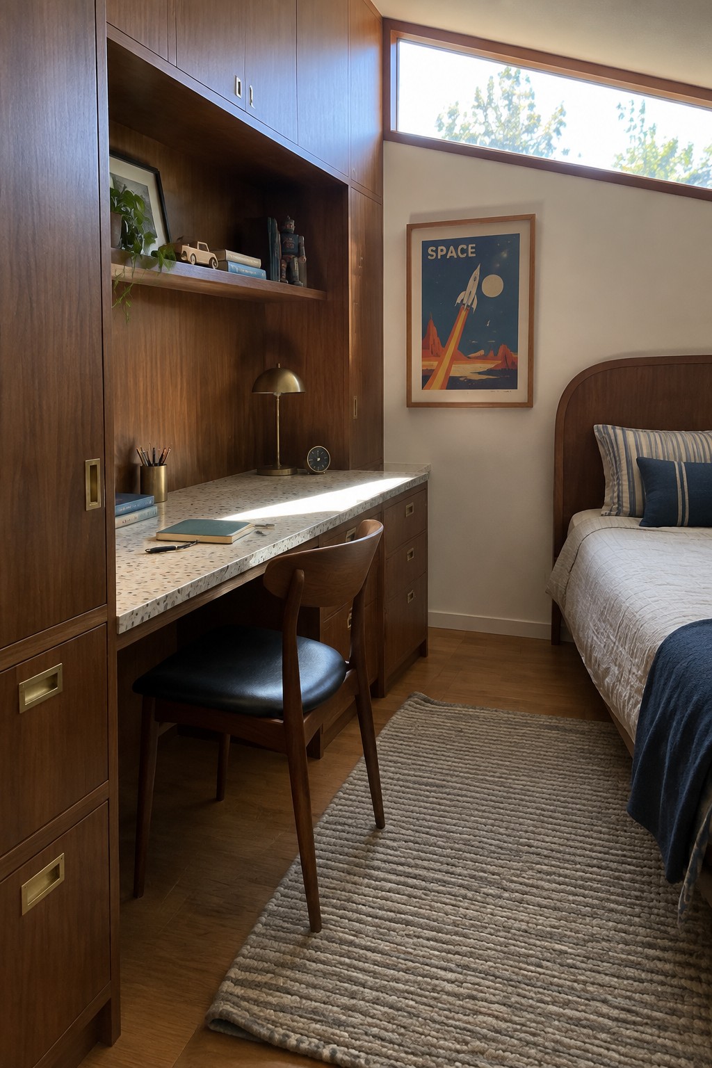 A bedroom interior with a built-in wooden desk and cabinetry, a wooden chair with black seat, a bed with striped pillows, and a space-themed poster on the wall.