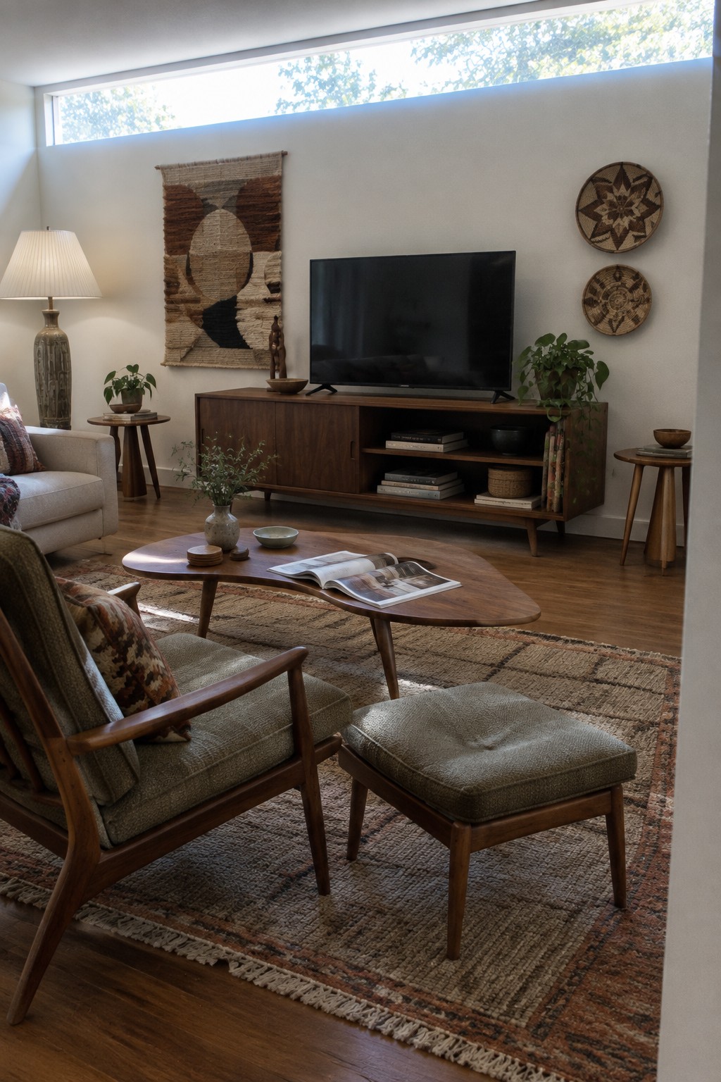 Mid-century modern living room with walnut TV console, coffee table, and woven wall hangings.