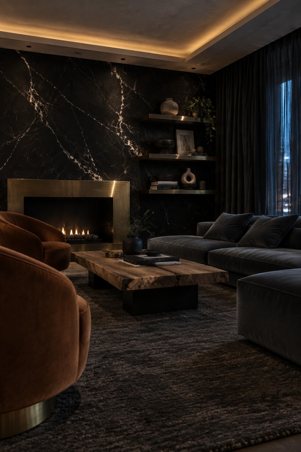 A modern living room with a black marble wall, brass-framed fireplace, dark velvet sectional, brown velvet armchairs, and wooden coffee table on a textured rug.