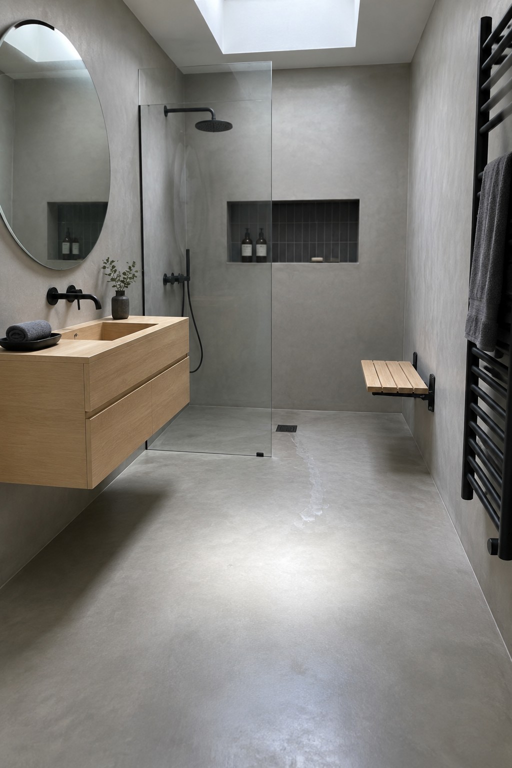 Modern minimalist bathroom with wooden vanity, round mirror, glass shower, black fixtures