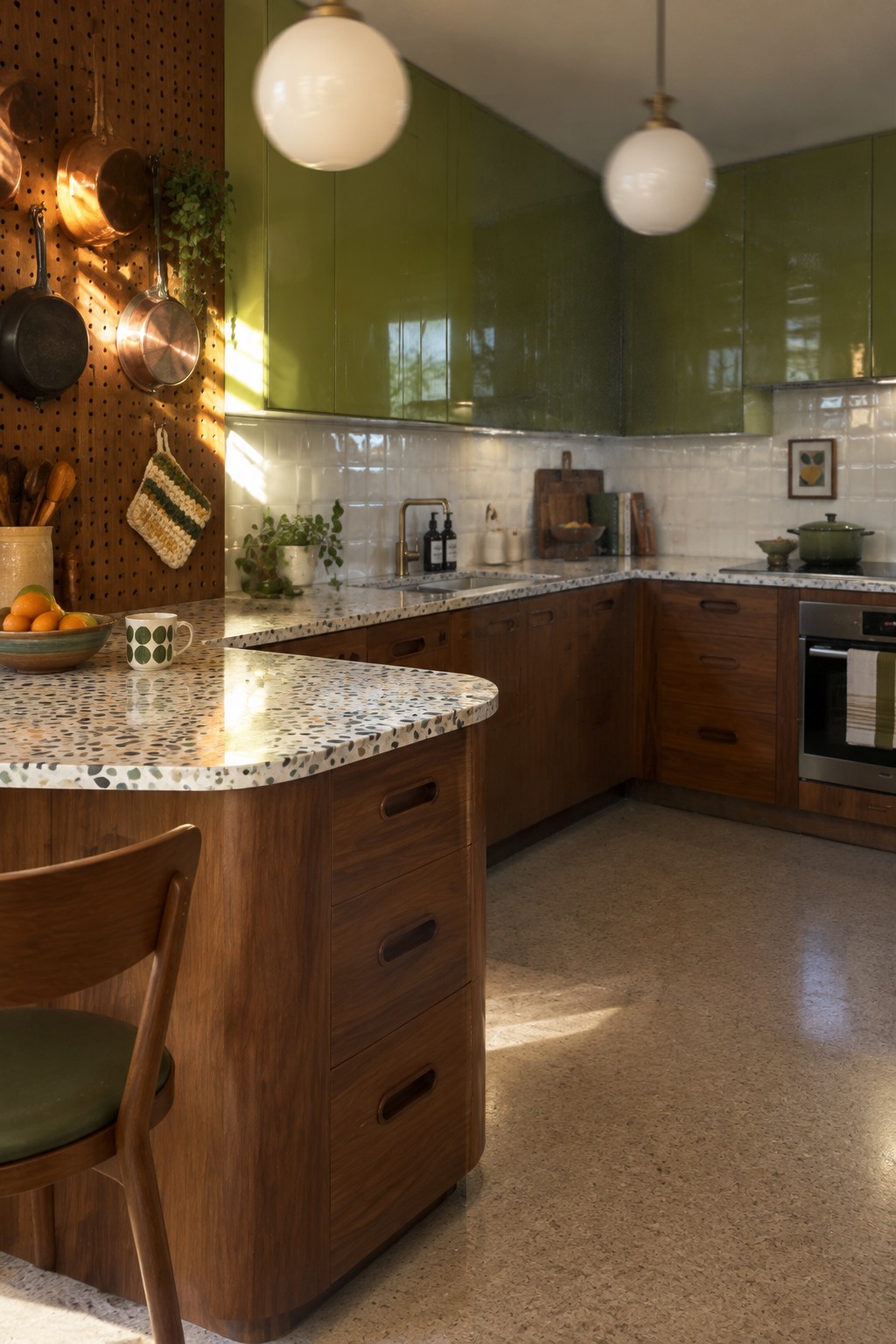 Modern kitchen with green cabinets, wooden island, terrazzo counters, and pendant lights