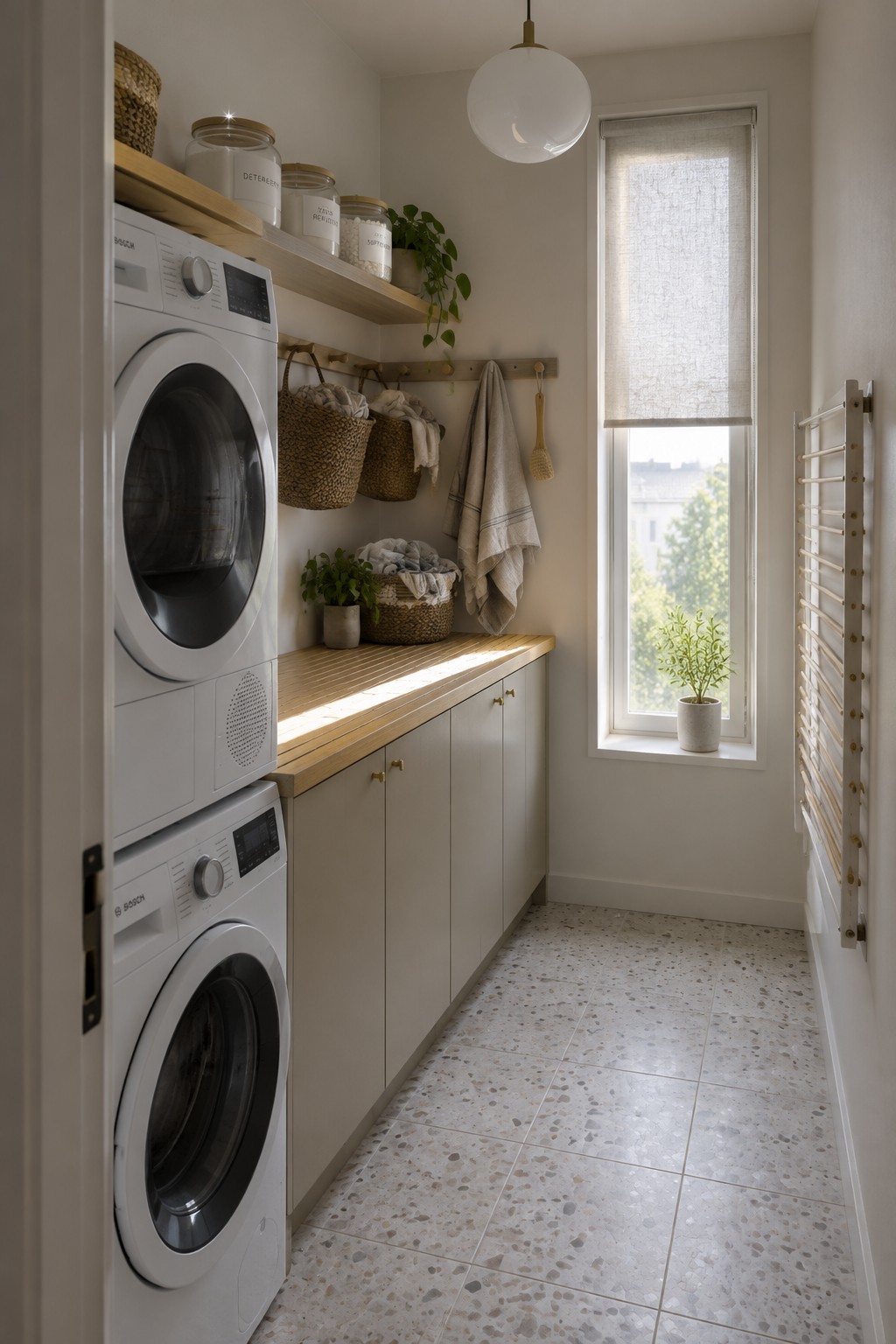 Modern laundry room with stacked Bosch washer-dryer, wooden shelves, baskets, and terrazzo floor